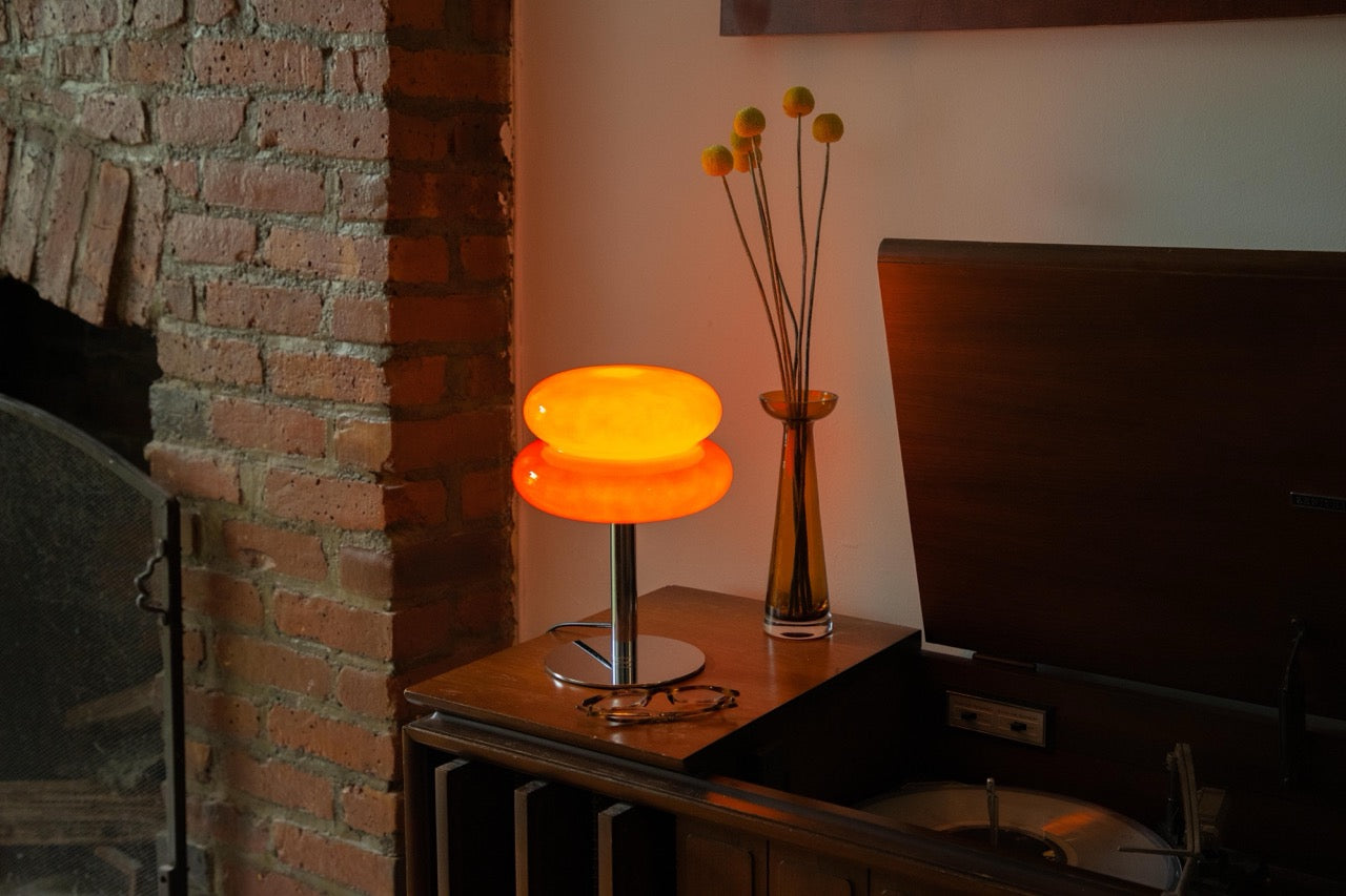 The Capella - Lucy’s Lamps retro stained glass orange table lamp serves as a modern table lamp for bedroom or living room. This small desk lamp is perfect as a bedside table lamp, side table lamp, light therapy lamp, and aesthetic lamp for minimalist spaces. Explore Lucys Lamps for more home lighting ideas.